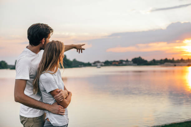 istock Positive man hugging glad girl in nature 1143256991