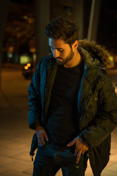 istock Cool young man in the city at night 1143257106