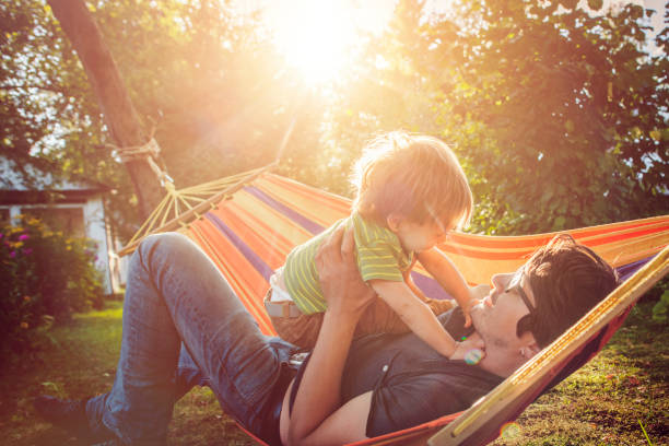 istock Family enjoying spring/summer day in hammock 1143257576