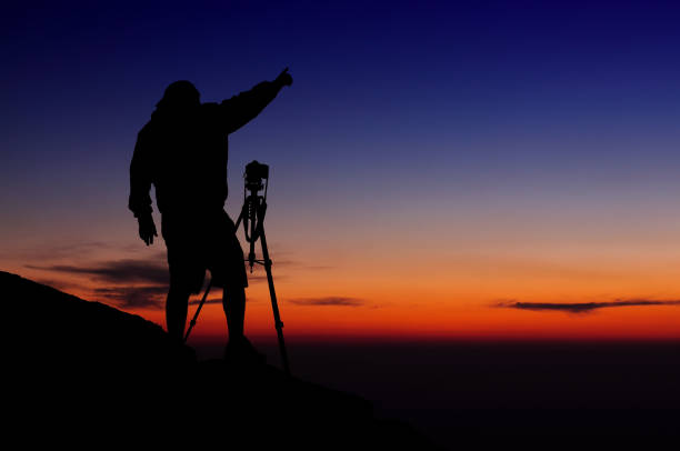 istock Photographer silhouette at sunset 1143257629