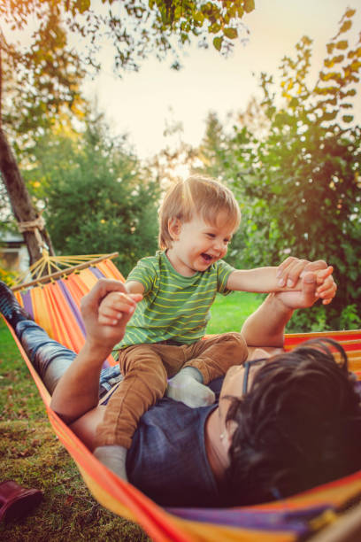 istock Family enjoying spring/summer day in hammock 1143258220
