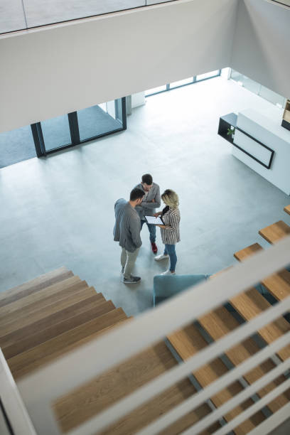 istock Three busuiness people having a casual talk in hall 1143258303