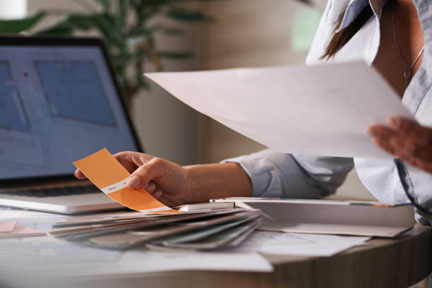 istock Unrecognizable businesswoman choosing  color from a palette while working on new project. 1143258530