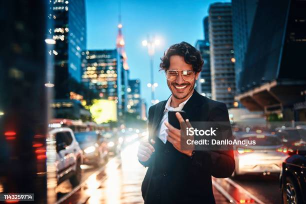 Handsome Businessman Using His Smartphone In The City Stock Photo - Download Image Now