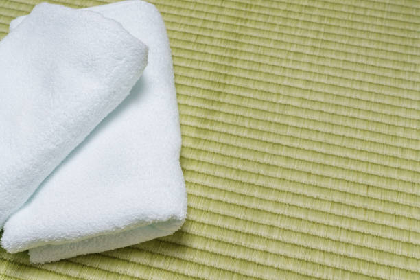 Stack of clean towels on tatami-mat Stack of clean towels on tatami-mat beach mat stock pictures, royalty-free photos & images