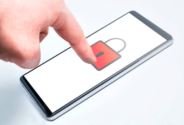 A human hand touches the touchscreen of a modern technological smartphone with an index finger with a padlock icon for computer security stock photo