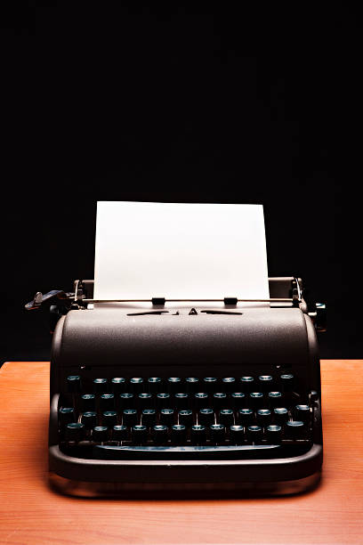 istock Low-key vintage manual typewriter with blank paper 114326147