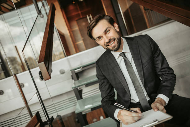 istock Happy unshaven businessman making notes during labor 1143262504
