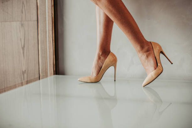 Girl legs in bright stylish stiletto shoes Close up fashion feet wearing fashion beige shoes on high heels inside. Style concept high heels stock pictures, royalty-free photos & images