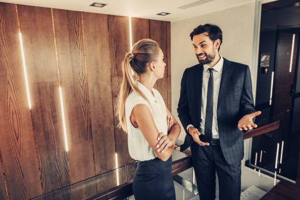 istock Optimistic male employee telling with calm colleague 1143262573