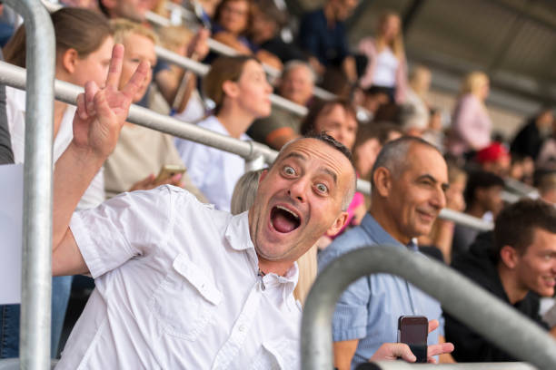 istock Spectator showing peace sign in stadium 1143265447
