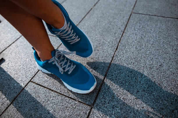 istock Man feet in the modern bright sneakers 1143265631