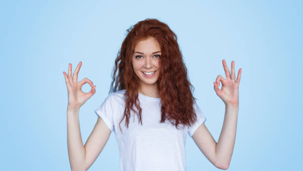 istock Cheerful red-haired woman gesturing OK 1143266087