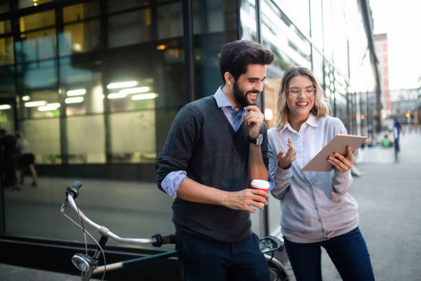 istock Beautiful young couple walking down the street with tablet 1143268776
