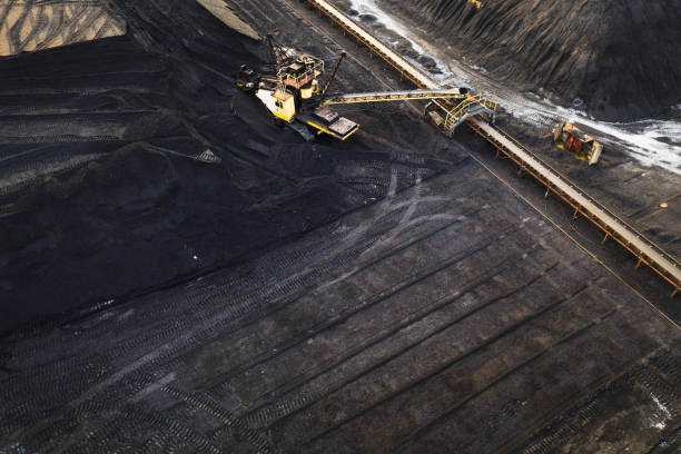 istock Aerial view on yellow excavator and conveyor in coal storage. 1143269307