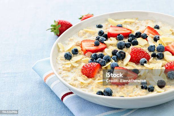 Oatmeal Breakfast Cereal With Berries And Almonds On Linen Stock Photo - Download Image Now