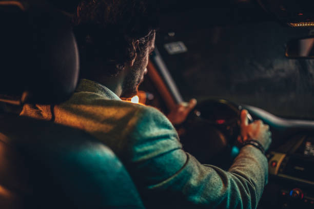 istock Gentleman driving a car at night 1143271024