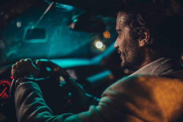 istock Charming gentleman driving a car at night 1143271652