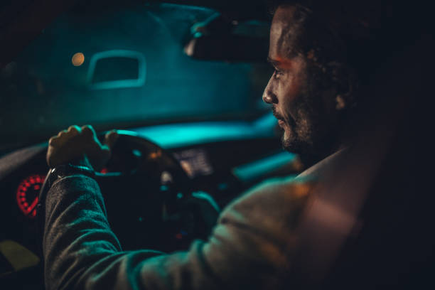 istock Gentleman driving a car at night 1143271662