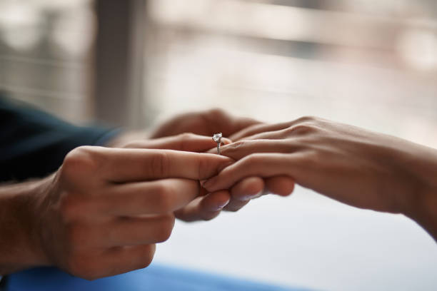 istock Man making marriage proposal to woman in restaurant 1143272303