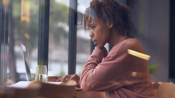istock young African woman using laptop indoor 1143273099