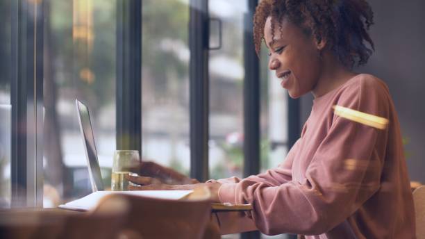 istock young African woman using laptop indoor 1143273144