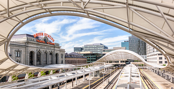 Denver, USA - A panoramic image showing the tracks of Denver's Union Station partially covered by the canopy architecture.