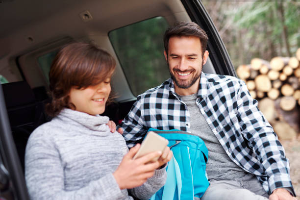istock Smiling man and his son during spring road trip 1143275003