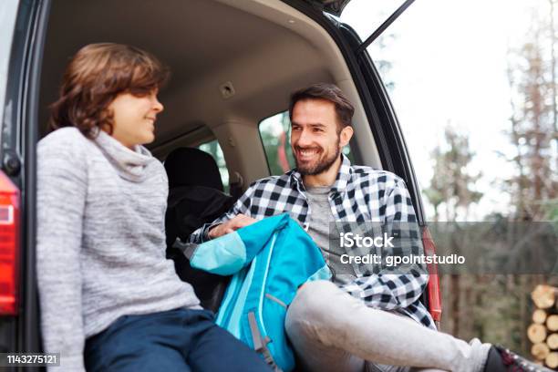 Smiling Father And Son Taking A Short Break During Spring Hiking Stock Photo - Download Image Now