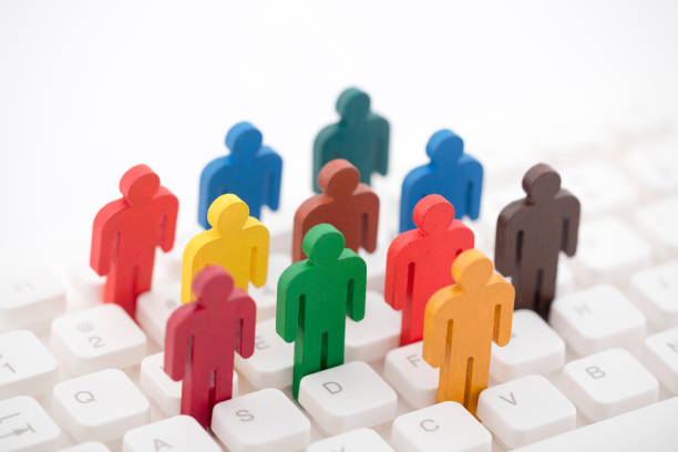 istock Colorful painted group of people figures on computer keyboard 1143275499