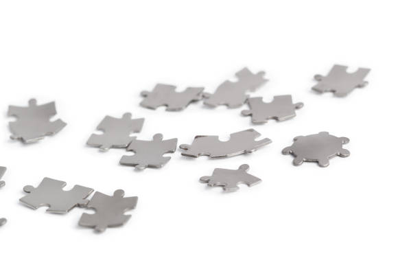 istock Metal puzzle pieces isolated on white 1143275582