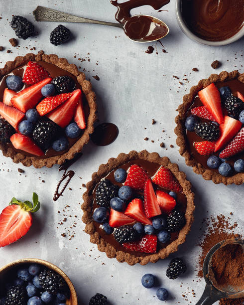 Chocolate tarts with fresh berries Chocolate tarts with fresh berries on gray marble background tart dessert stock pictures, royalty-free photos & images
