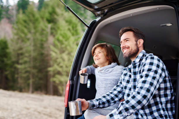 istock Man and his son enjoying the view during road trip 1143276152