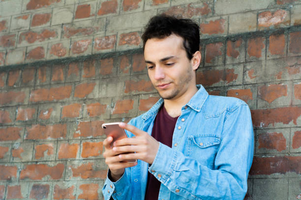 istock Young man typing on his phone. 1143276843