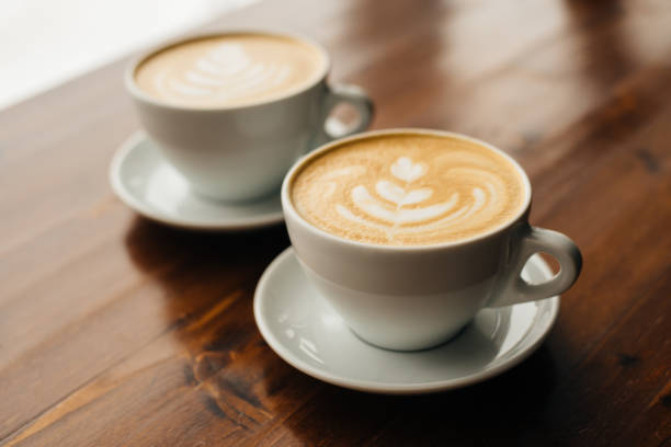 istock Two cups of cappuccino on the wooden table. 1143277122