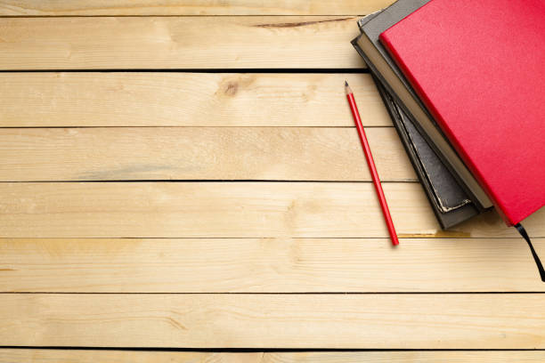 istock Wooden table with office supplies, top view 1143277484