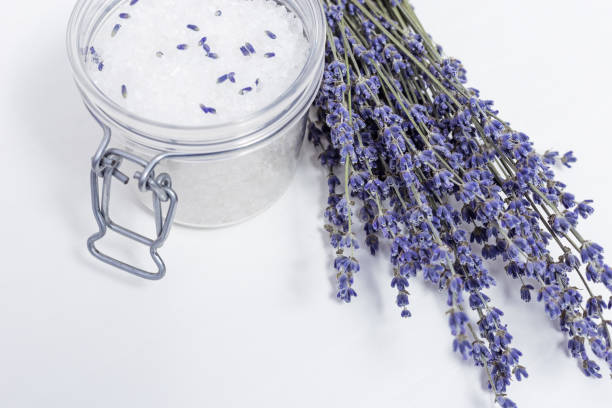 Lavender flowers and round jar with sea salt. Spa concept. Selective focus.