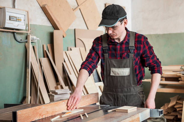 istock Carpenter worker cutting wooden board 1143278817
