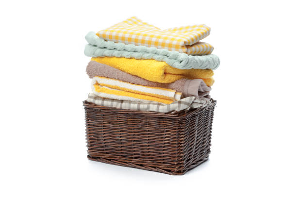 istock Clothes in a laundry wooden basket isolated on white background 1143279554