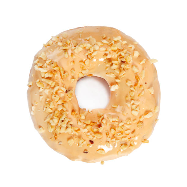 istock Donut with caramel icing and nuts isolated on white 1143279583