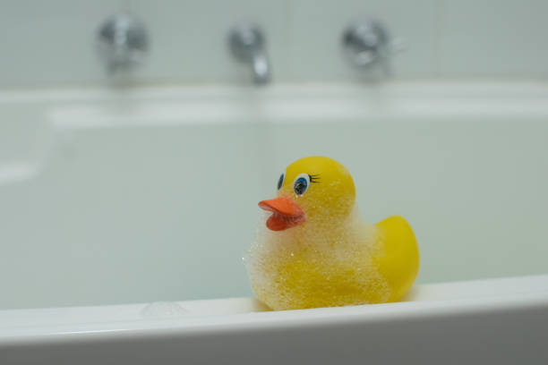 istock Happy yellow rubber duck having a bath in the bubble warm bath 1143280317