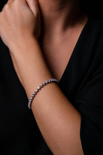 istock Womens silver bracelet with stones dressed in hand. 1143281373