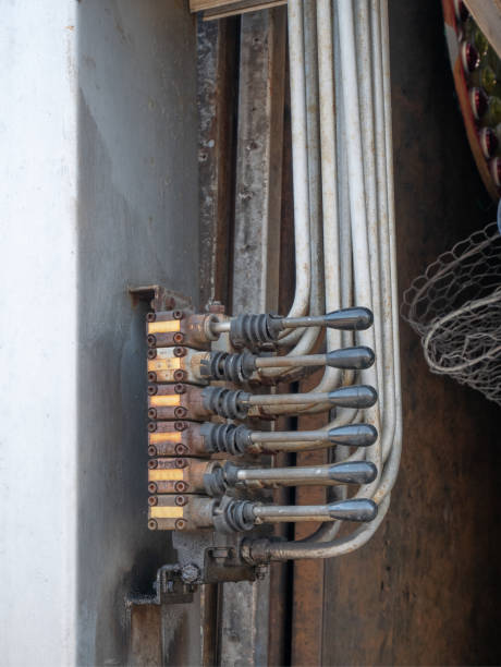 istock closeup of hydraulic system levers with metallic pipes 1143282082