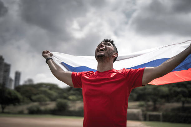istock Male fan holding russian flag 1143282150