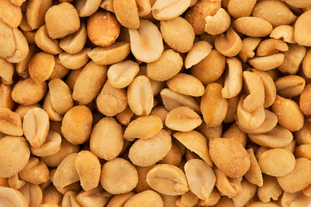 istock Close up on stack of salty peanuts as abstract background. 1143283223