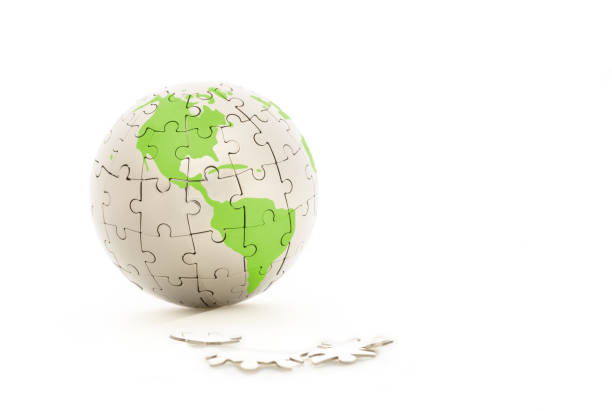 istock Earth jigsaw puzzle with green world map on white background 1143283312
