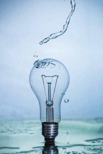 istock Bulb lamp with motion freezed water splashes. 1143283375