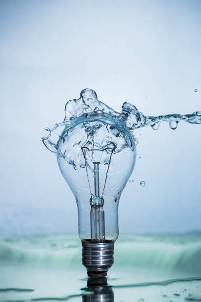 istock Bulb lamp with motion freezed water splashes. 1143283455