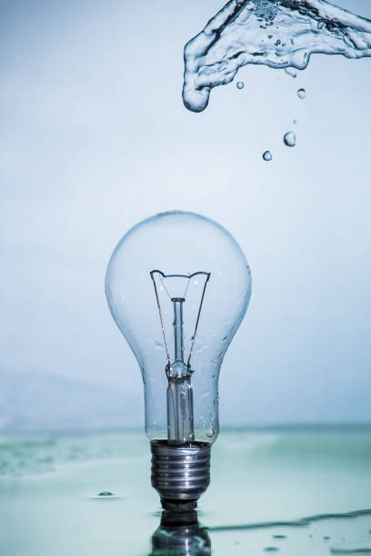 istock Bulb lamp with motion freezed water splashes. 1143283548