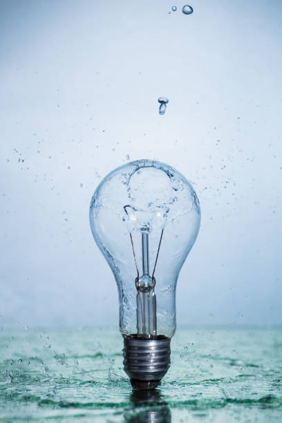 istock Bulb lamp with motion freezed water splashes. 1143284217